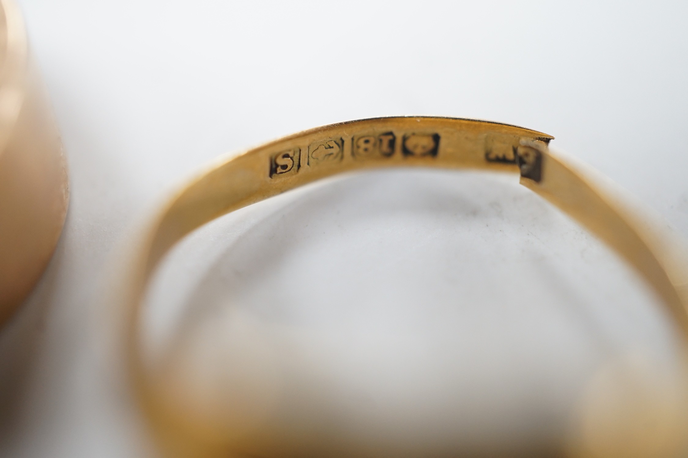 A 1930's 22ct gold wedding band, size K, 4.1 grams, a 9ct gold wedding band, size Q, 9.3 grams and a broken 18ct gold signet ring, 2.9 grams.